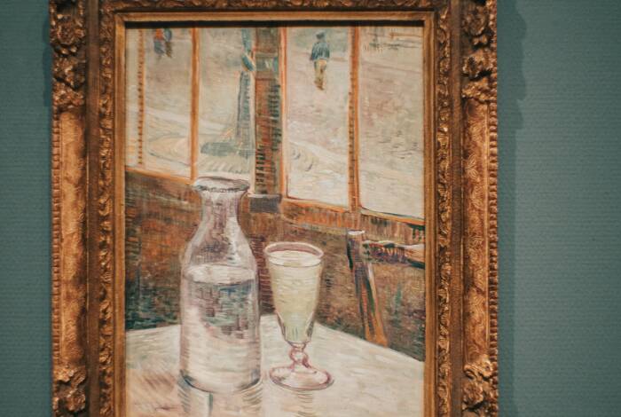 The painting "Coffee Table with Absinthe" (1887) | Unsplash: Jean Carlo Emer